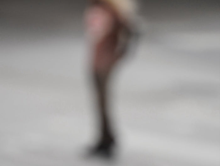 Blurred image of a person in a dark setting